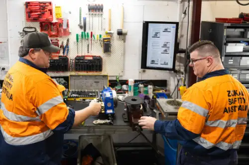 Technicians servicing equipment